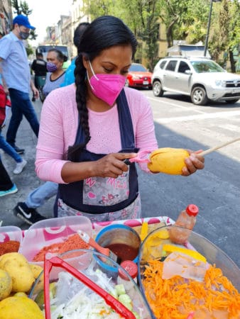 Maria peels an Ataulfo mango at her cart in Mexico City, photo by Paco de Santiago Ataulfo mango Mexico City