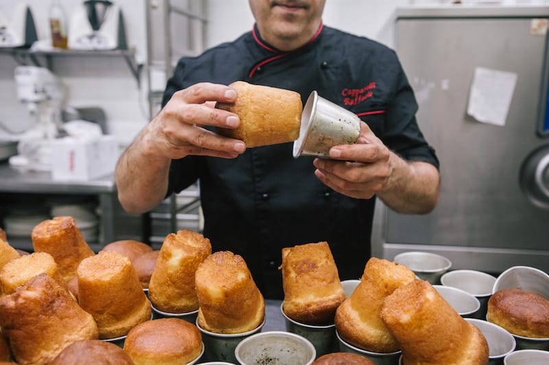 Raffaele Capparelli, owner of Pasticceria Capriccio, pulls out freshly baked babàs, photo by Gianni Cipriano and Sara Smarrazzo
