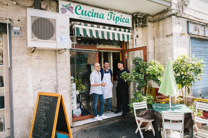 Antonio Ziccardi (center) stands in front of Cucina da Vittorio, located in the Fuorigrotta neighborhood, photo by Gianni Cipriano and Sara Smarrazzo