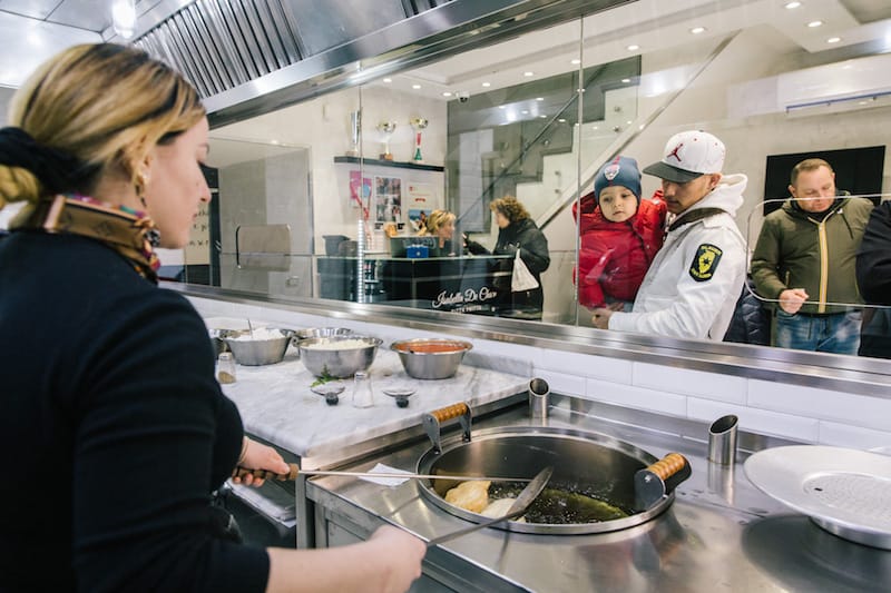Isabella De Cham fries a pizza in her pizzeria in Naples' Sanità district, photo by Gianni Cipriano and Sara Smarrazzo