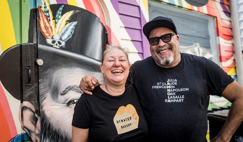 couple in front of New Orleans mural