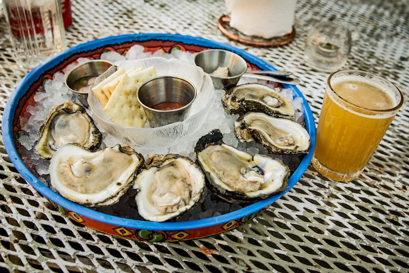 At Seafood Sally’s, plump, freshly-shucked oysters arrive with the traditional sauce for dipping, along with a ramekin of a tangy mignonette sauce fortified with a hint of Vietnamese fish sauce, photo by Pableaux Johnson