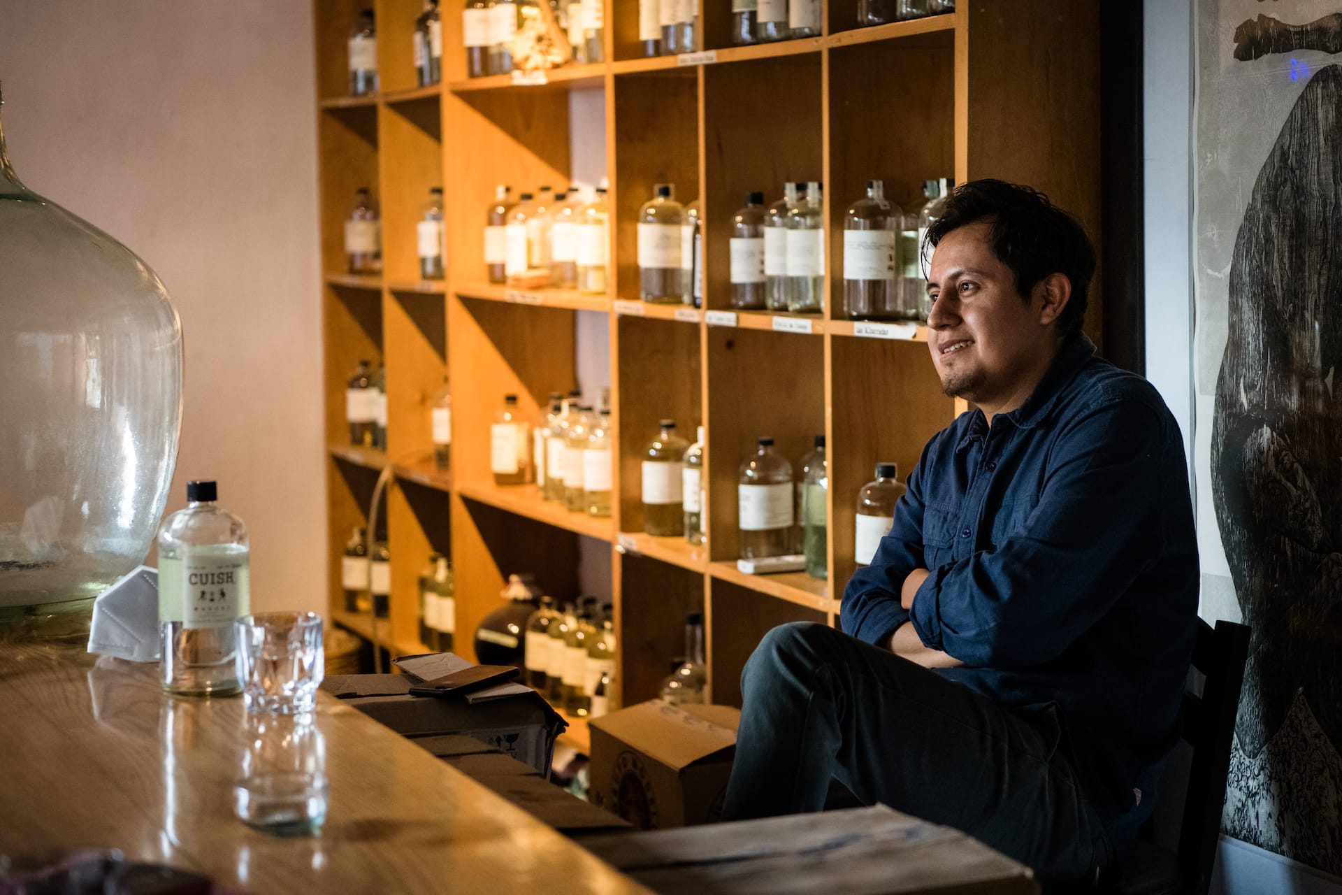 Felix Monterroza is the fourth generation to make and sell mezcal, and he is the founder of Cuish in Oaxaca, photo by Jalil Olmedo man sitting at mezcal bar