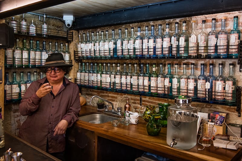 Ulises Torrentera samples mezcal at In Situ, the mezcaleria he co-founded with Sandra Ortiz Brena in Oaxaca, photo by Jalil Olmedo