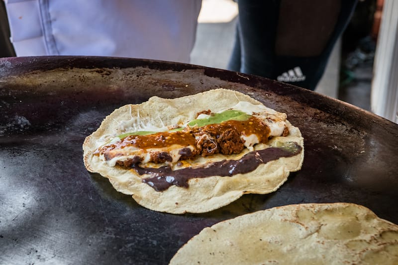 Tacos on the comal at Tacos de Cazuela del Carmen Alto, photo by Jalil Olmedo tacos oaxaca