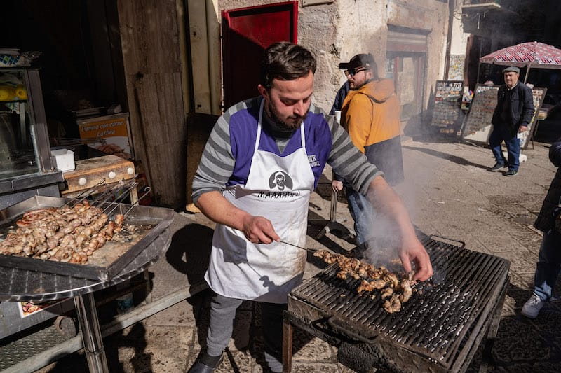 Street vendor of stigghiola (lamb gut), Ballaro market, Palermo, photo by Francesco Cipriano