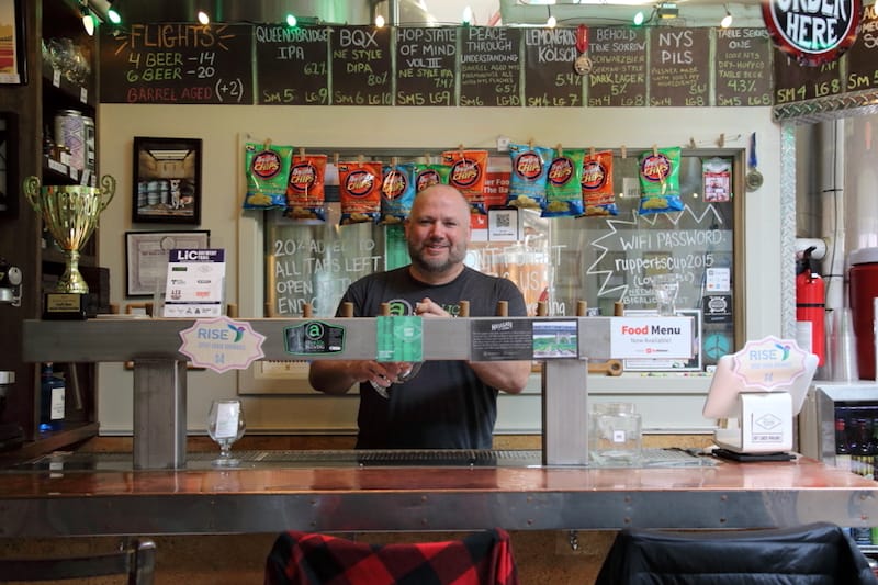 Co-founder Kyle Hurst behind the tap at Big aLICe Brewing in Long Island City, photo by Dave Cook