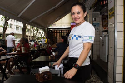 A server at Ziza Bar with her high-tech wristwatch, photo by Vinicius Camiza
