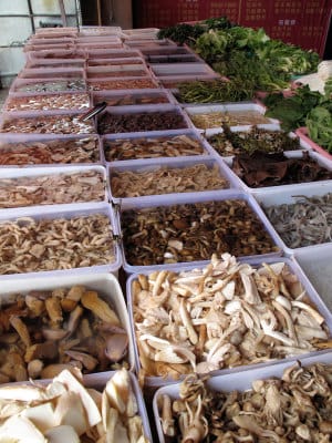 Fresh mushrooms for sale at a market stall, photo by Lillian Chou