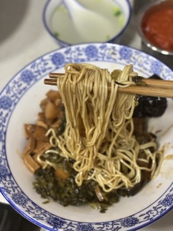 At San Lin Tang, the multi-generational family of wonton and noodle makers make a bowl, photo by DJ Zhang