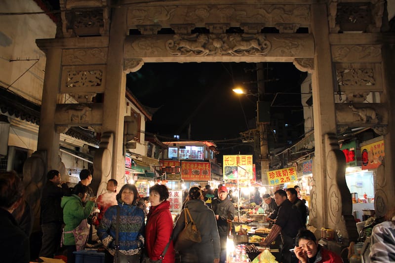 An outdoor market in Shanghai at night, photo by Jamie Barys and Kyle Long