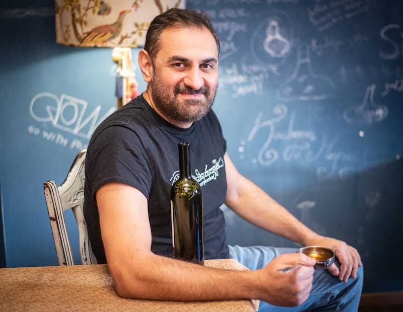 Luarsab Togonidze, folklorist, entrepreneur, author and co-owner of Azarphesha and sister restaurant, Poliphonia, holds a 19th-century silver azarphesha, a vessel for drinking "special" toasts, photo by Justyna Mielnikiewicz