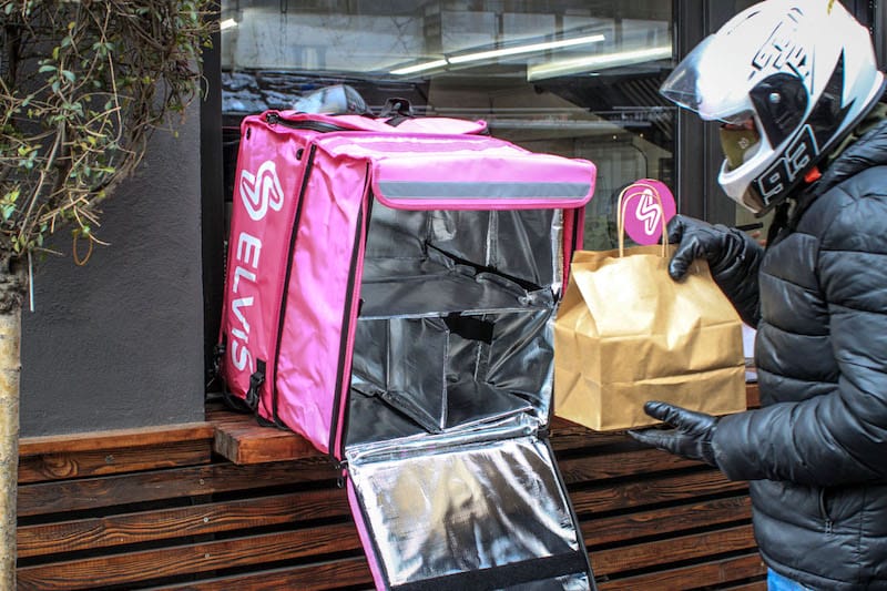 An Elvis courier loads his box at a local sandwich shop in Tbilisi, photo by Paul Rimple