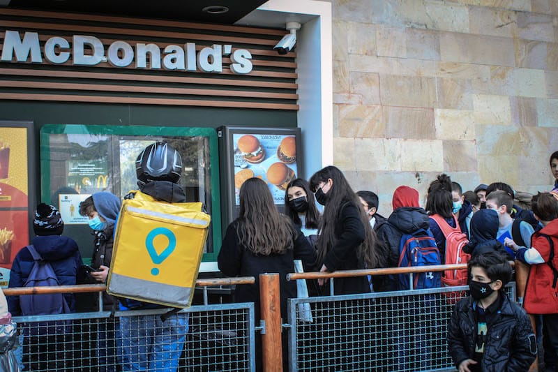 A courier for Glovo, a Barcelona-based company, waits for an order at McDonald’s in Tbilisi, photo by Paul Rimple