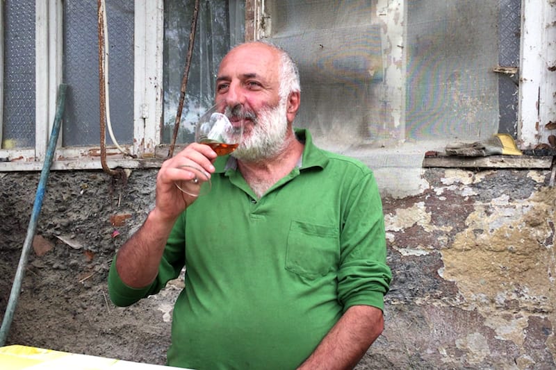 Winemaker Soliko Tsaishvili tasting one of his orange wines. © Emily Railsback c/o Music Box Films
