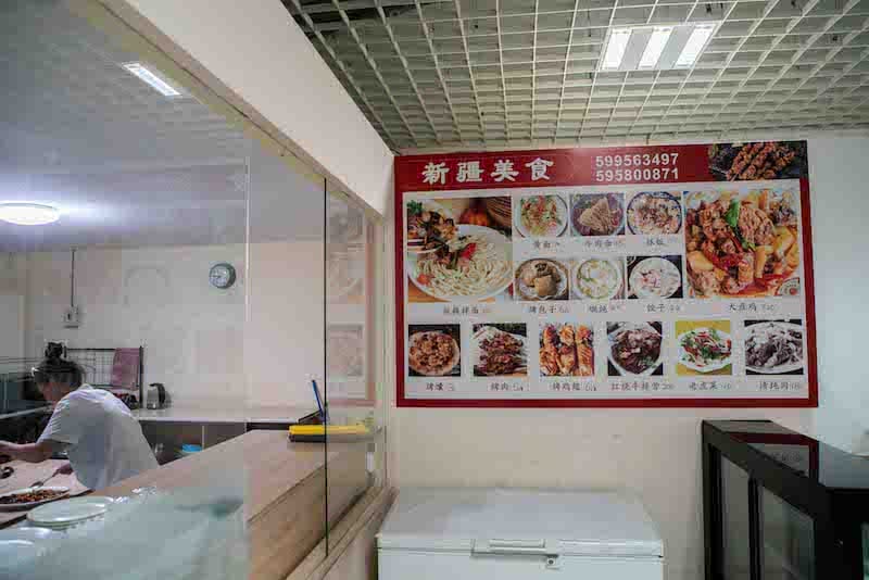 The wall-mounted menu shows the house specialties and prices. All dishes above 100 gel are large portions meant for 4-5 persons and have to be pre-ordered, photo by Pearly Jacob