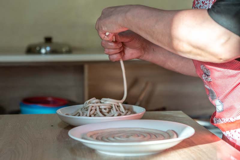 Dilbar has trained her local Azerbaijani-Georgian helpers with whom she can communicate in a common Turkic dialect, to knead and hand pull noodles for Uighur lagman, photo by Pearly Jacob