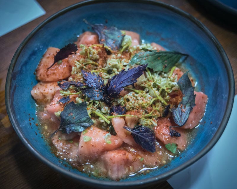 A simple tomato salad with jonjoli and basil doused in Kakhetian sunflower oil, photo by Justyna Mielnikiewicz