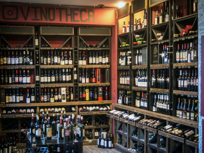 Bottles of wine line the walls in Vinotheca, photo by Paul Rimple