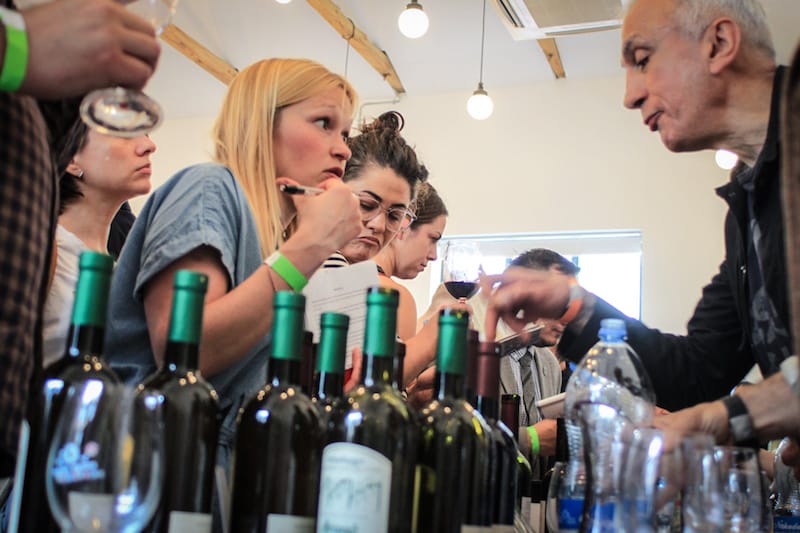 A winemaker explains his wine to a guest, photo by Paul Rimple