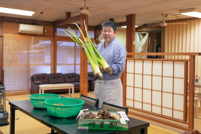 Chef Ito holding huge zuiki (taro stems), photo by Derek Yamashita