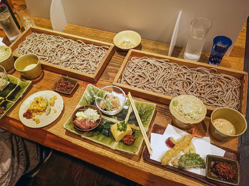 Itasoba, giant wooden trays of buckwheat noodles, at Kaoriya in Ebisu, where makeshift screens divide the shared tables, photo by Phoebe Amoroso