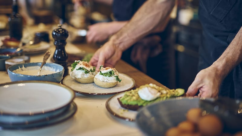 Eggs Commodore is finished with cashew cream sauce and a sprinkle of Piment D’esplette, photo by Alex Fisher
