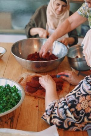 A group of Syrian women preparing beets for the weekly pop-up at Newcomer Kitchen in Toronto, photo by Mandy Sham newcomer kitchen toronto
