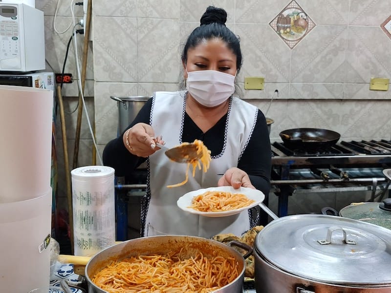 Elizabeth serves up a plate of pasta, a second course of comida corrida at Cocina Margarita, photo by Paco de Santiago